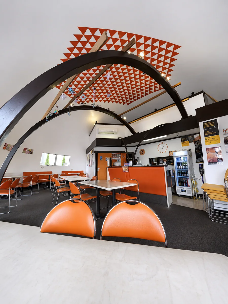 Cameron Japanese Family Restaurant dining room with orange chairs and curved roof